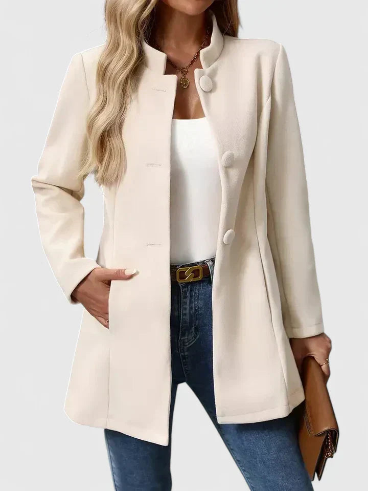 A woman wearing a tailored jacket with a neat stand collar and a button front