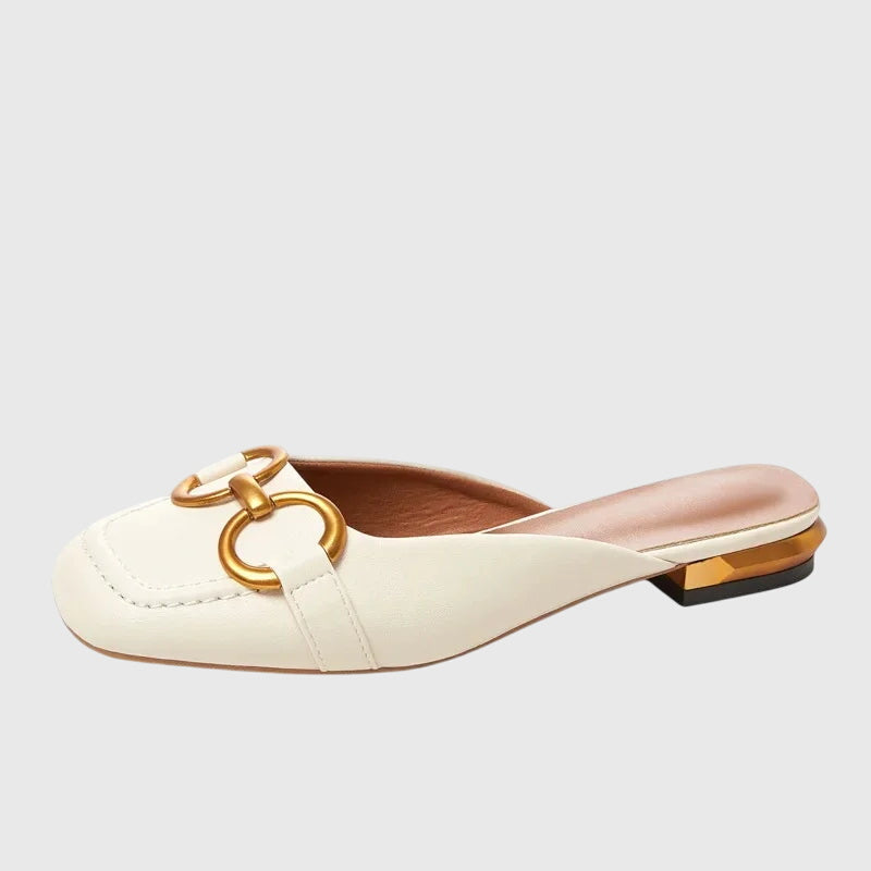 A woman walking easily in beige everyday support sandals with a broad, cushioned footbed.