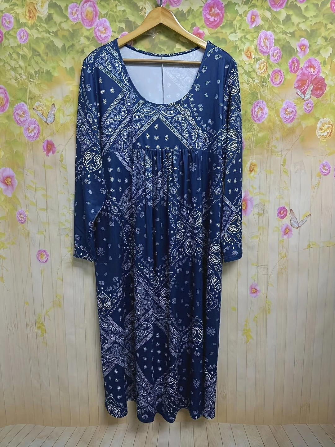 A woman wearing the Maureen long sleeve grey paisley midi dress with a square neckline and flowing skirt, styled for a relaxed day out.