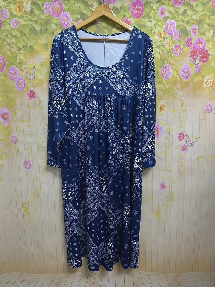 A woman wearing the Maureen long sleeve grey paisley midi dress with a square neckline and flowing skirt, styled for a relaxed day out.
