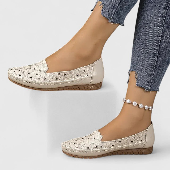 A woman wearing soft open-woven casual sandals on a warm, sunny day.