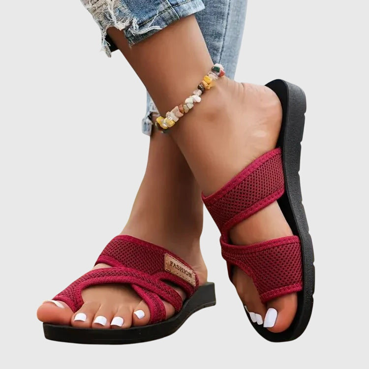 Lightweight flat sandal in black, also available in red and brown, with a simple clean design