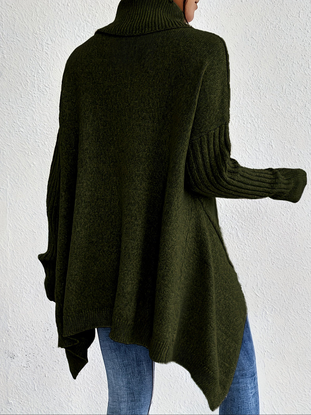 A woman wearing a stand-collar jumper with a chic asymmetric drape, warm and polished.