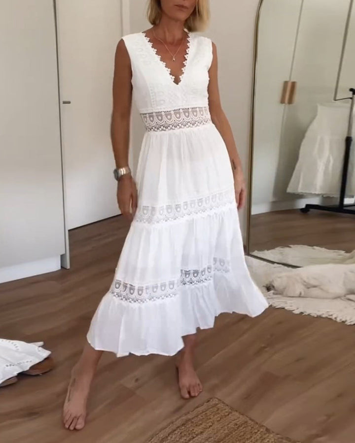 Woman wearing the Marian™ camisole maxi dress with delicate detailing and a flowing skirt at a summer gathering.