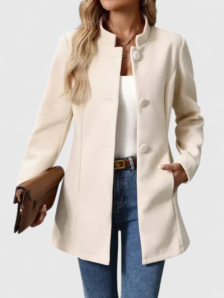 A woman wearing a collarless tailored jacket with a button front