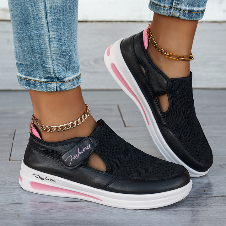 A woman slipping on breathable, cushioned slip-on trainers with trousers