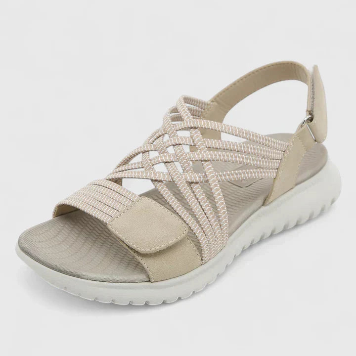 Blue open-toe sandals with woven stretch straps and a broad, cushioned white sole.