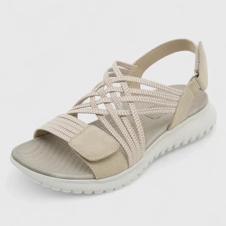 A woman walking freely in lightweight wide-fit orthopaedic sandals with an open front.