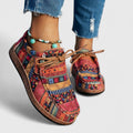 A pair of women's lace-up orthopedic comfort shoes in red with a cushioned sole and structured upper
