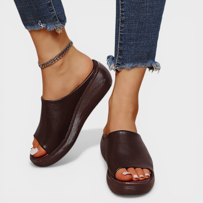 Open wedge mule sandals in white and brown with wide straps and a balanced wedge sole