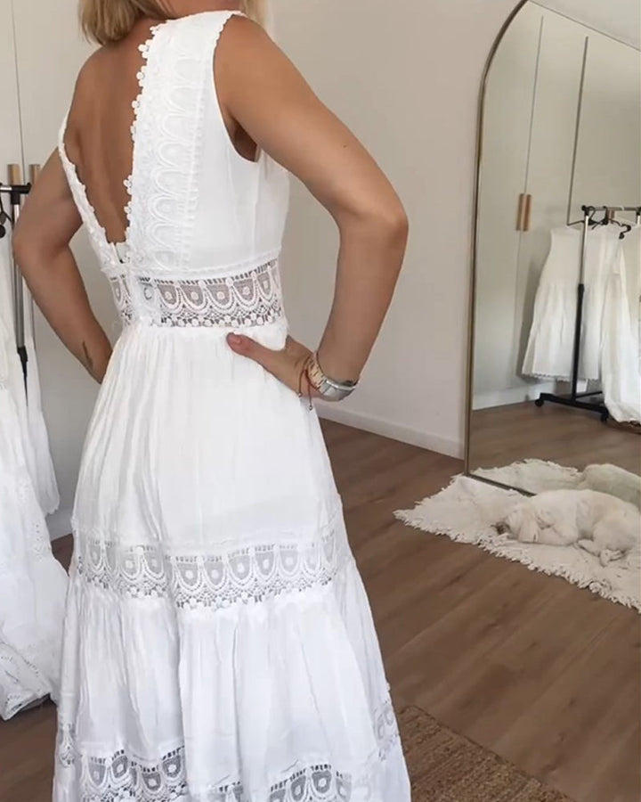 Woman wearing the Marian™ camisole maxi dress with delicate detailing and a flowing skirt at a summer gathering.