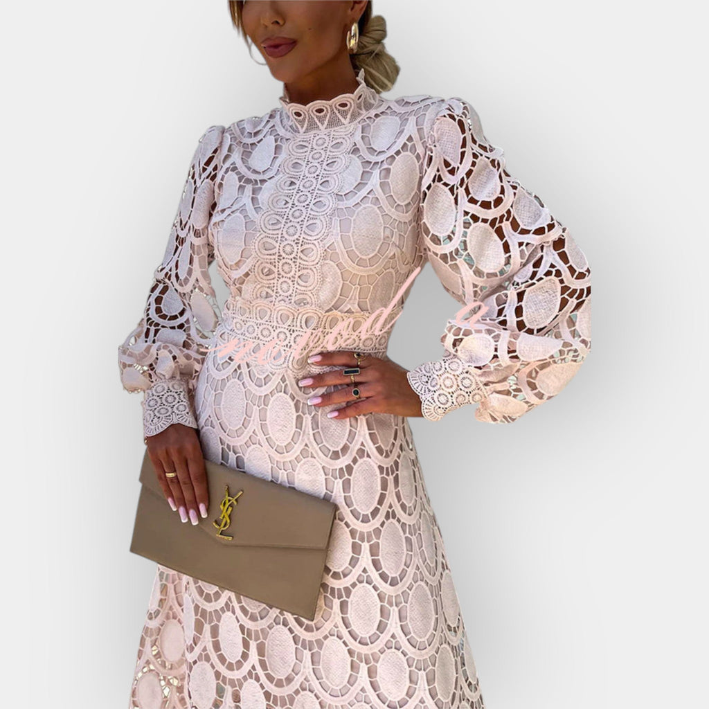 Romantic white openwork dress with voluminous puff sleeves and a graceful fitted silhouette