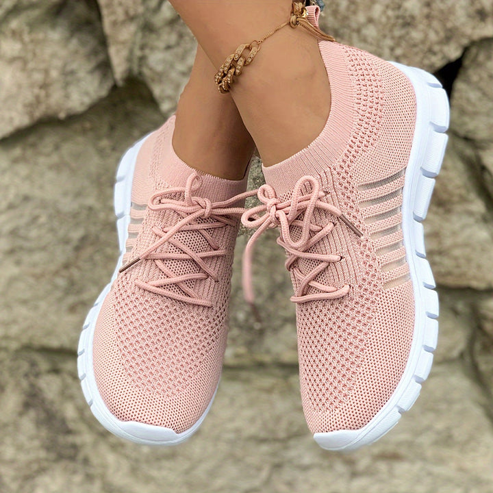 A woman wearing light breathable sock-style comfort shoes