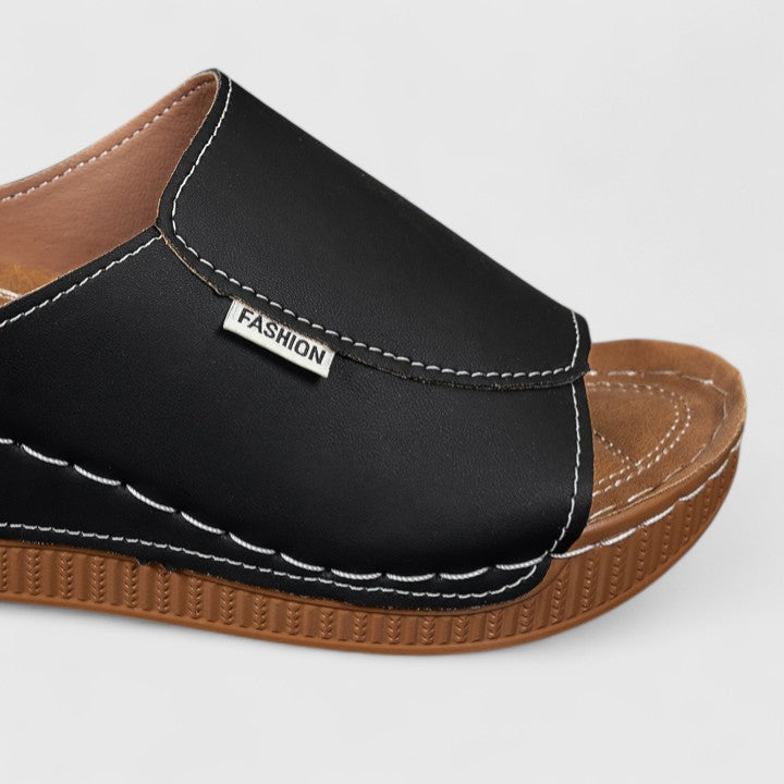 A woman in tan lightweight sandals stepping out gracefully, feet cushioned and supported.