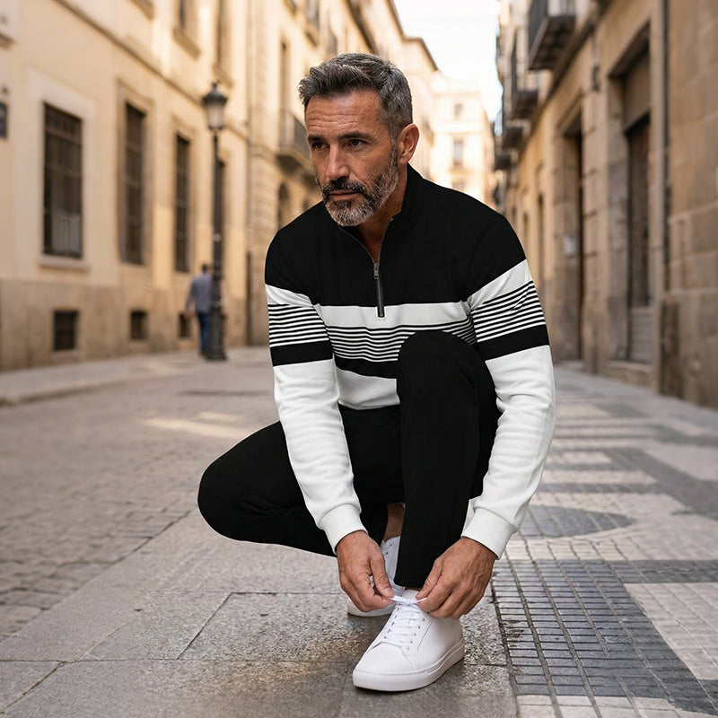 Men's black 2-piece leisure set with zip collar top and matching stripe trousers