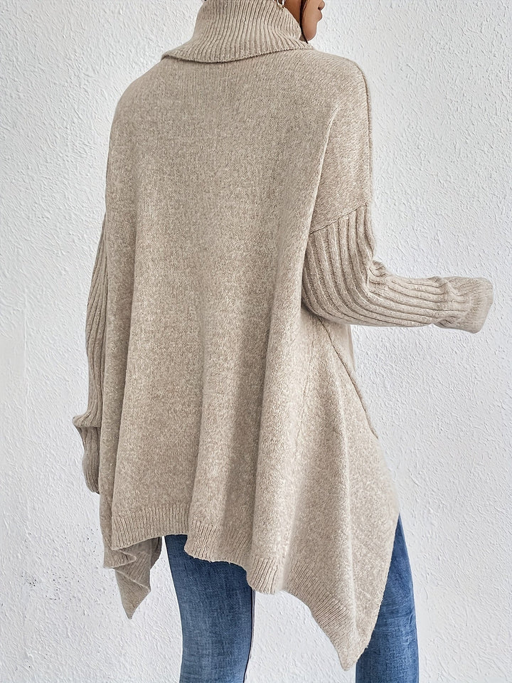A woman wearing a stand-collar jumper with a chic asymmetric drape, warm and polished.