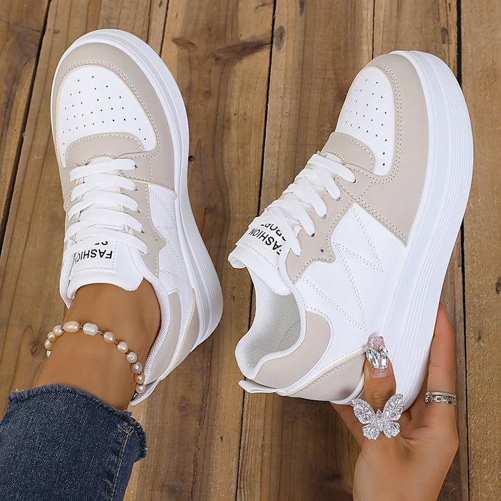 A woman wearing elegant two-tone platform trainers in the city