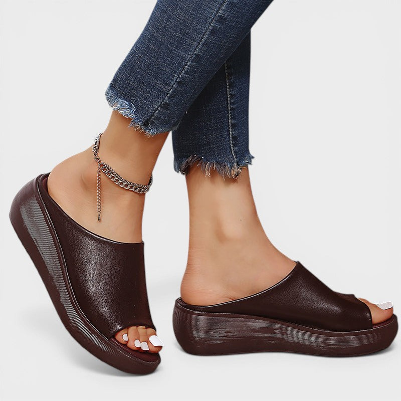 Open wedge mule sandals in white and brown with wide straps and a balanced wedge sole