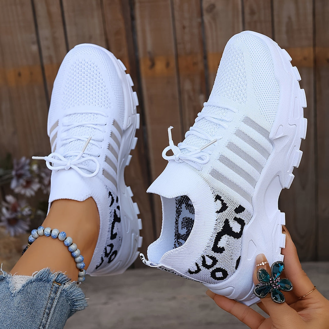 A woman walking in light, breathable comfort trainers on a warm day.