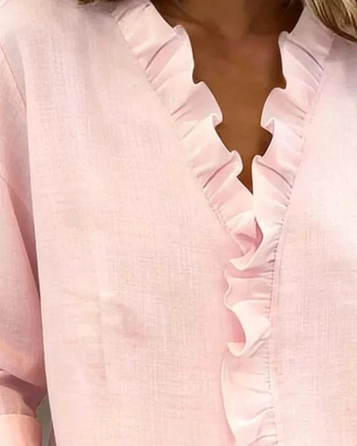 Pink women's V-neck blouse with decorative frill collar and long sleeves