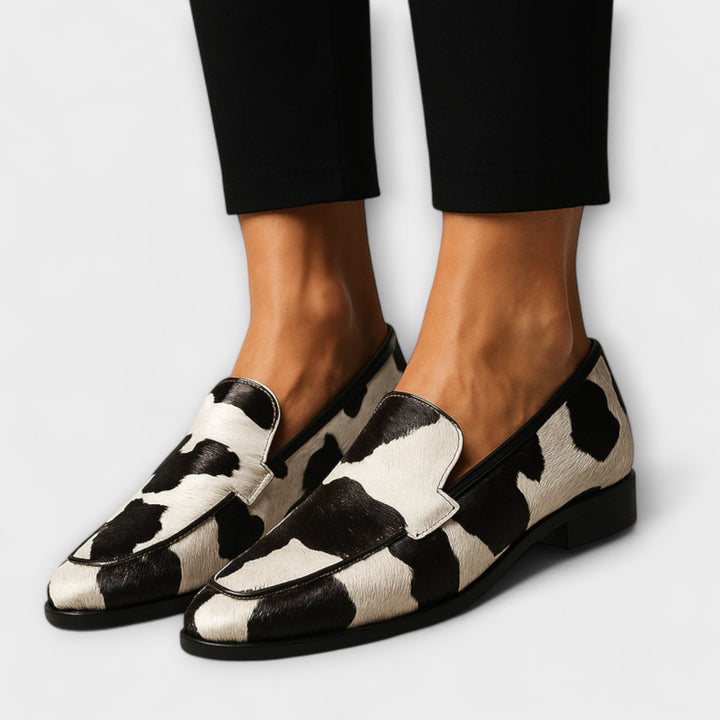 A woman wearing contemporary loafers with a modern, put-together outfit