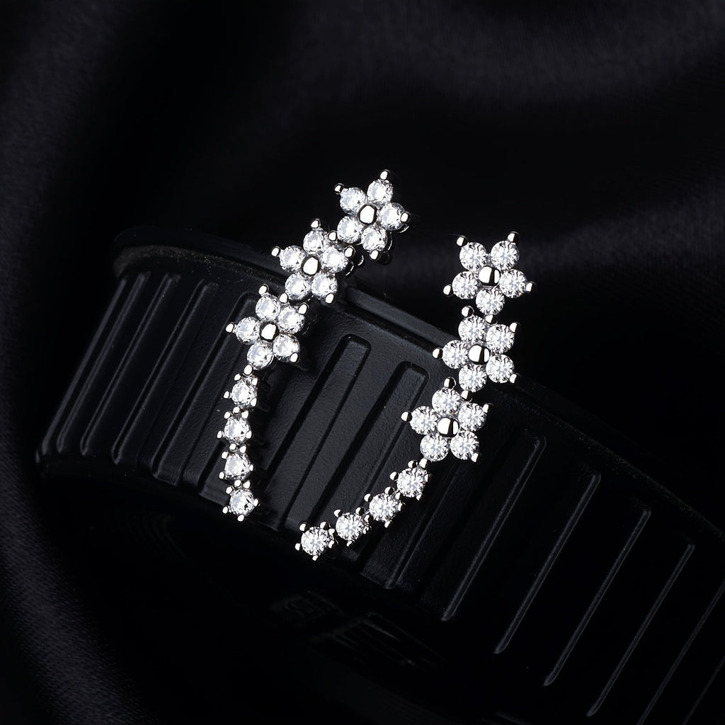Rose gold floral crawler earrings with delicate sparkling floral motif following the curve of the ear