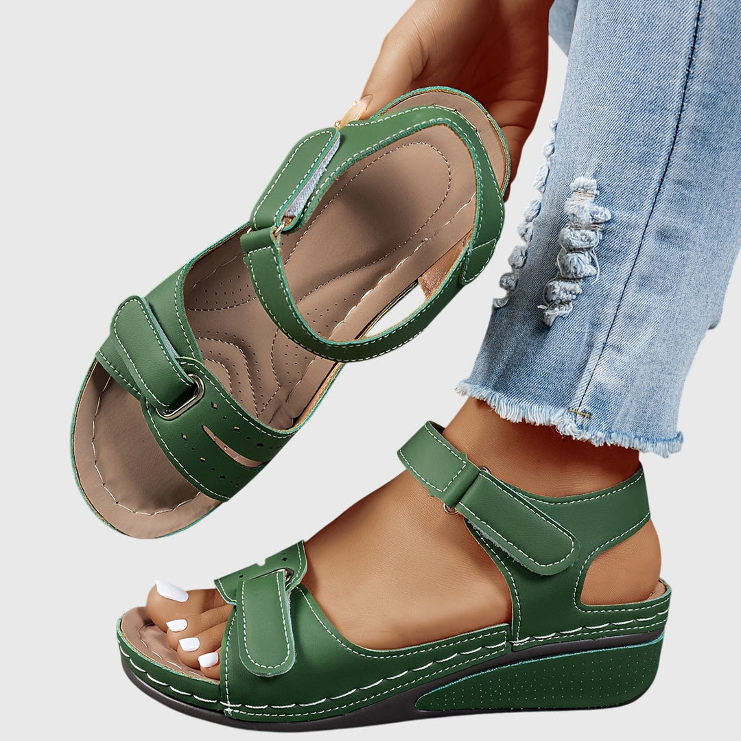 A woman wearing wide-fit supportive sandals with a relaxed summer outfit, walking with ease and confidence.