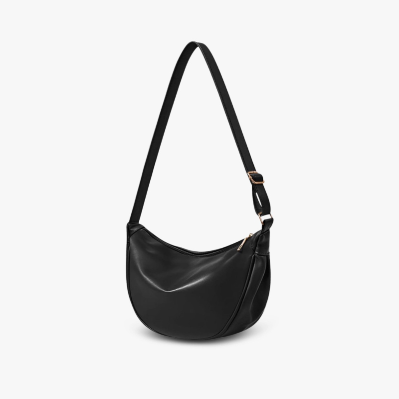 A woman carrying a soft pastel-toned bag with a rich finish on a spring day