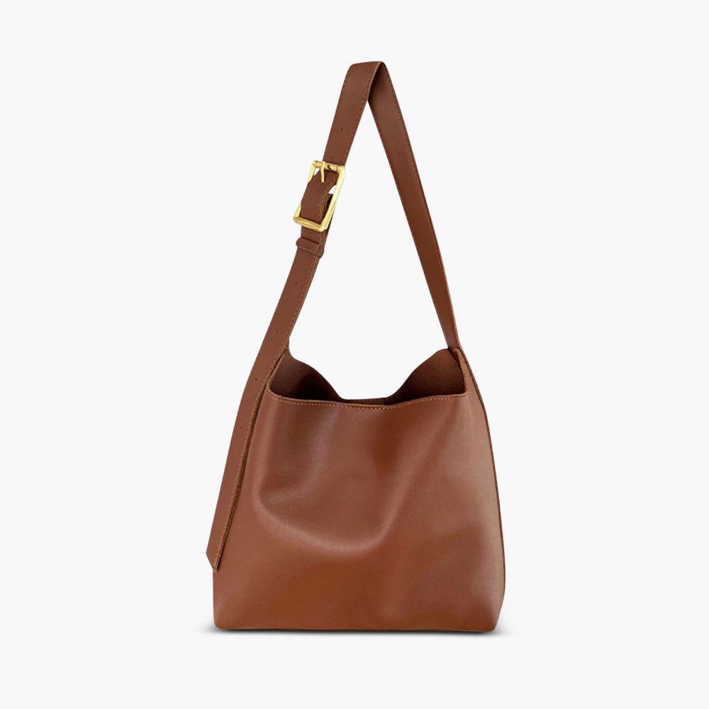 A woman carrying a classic structured handbag over her shoulder
