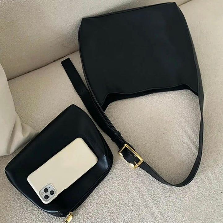 A woman carrying a classic structured handbag over her shoulder