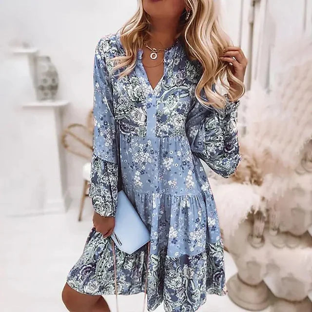 Woman in a relaxed boho dress with a colourful paisley and floral print.
