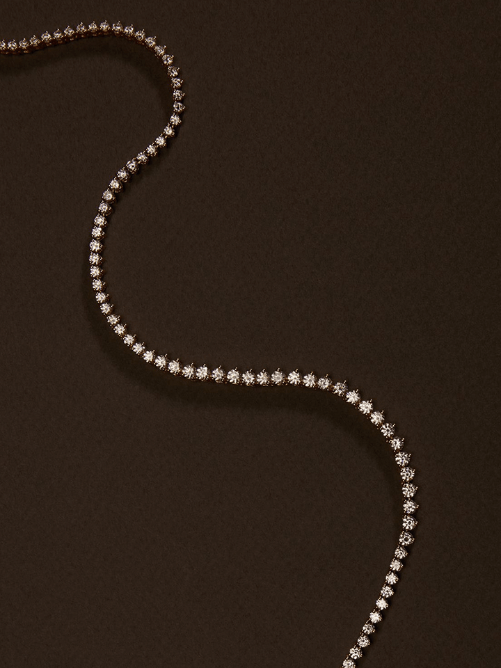 Rivière necklace with a continuous row of crystal stones in gold-plated finish