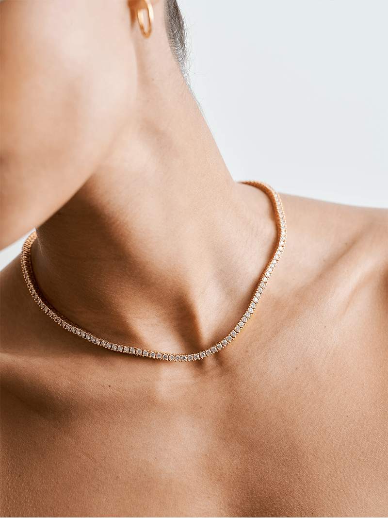 Rivière necklace with a continuous row of crystal stones in gold-plated finish