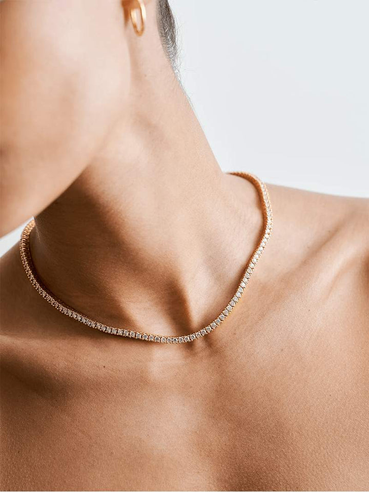 Rivière necklace with a continuous row of crystal stones in gold-plated finish