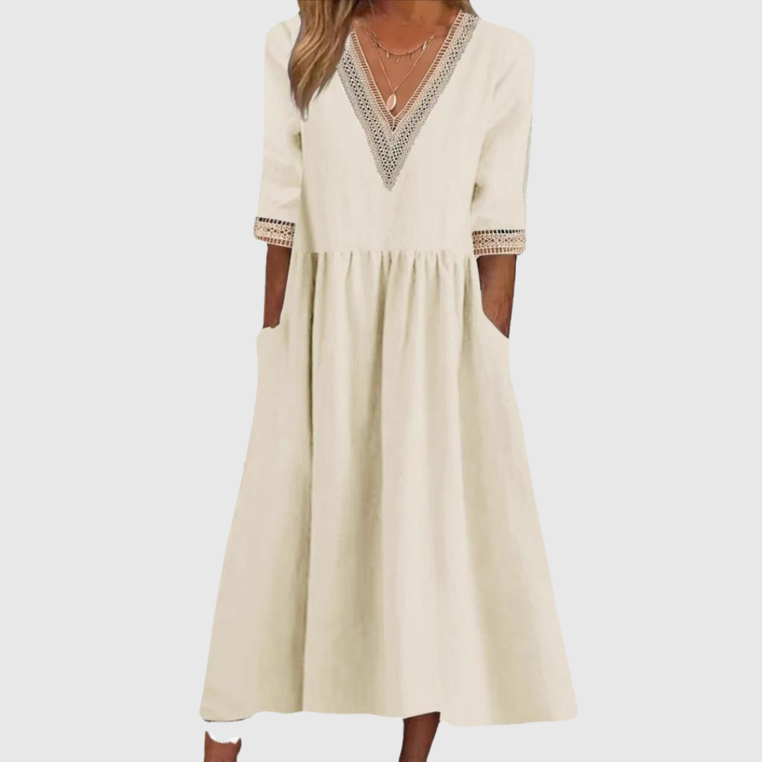 A woman wearing the Deirdre V-neck midi dress with delicate detailing at the collar and sleeves.