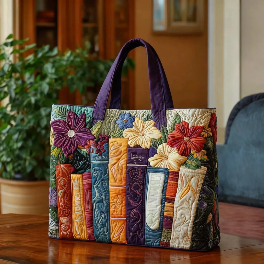 Quilted tote bag with a book lovers motif featuring stacked books and reading scenes on a structured padded body