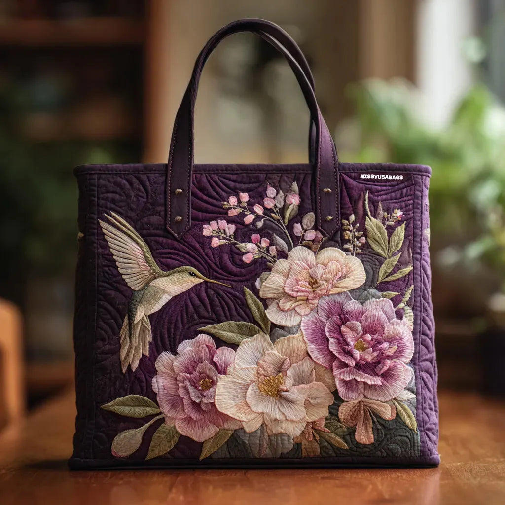 Quilted tote bag with hummingbirds and orchid flowers printed on a wave-stitch body