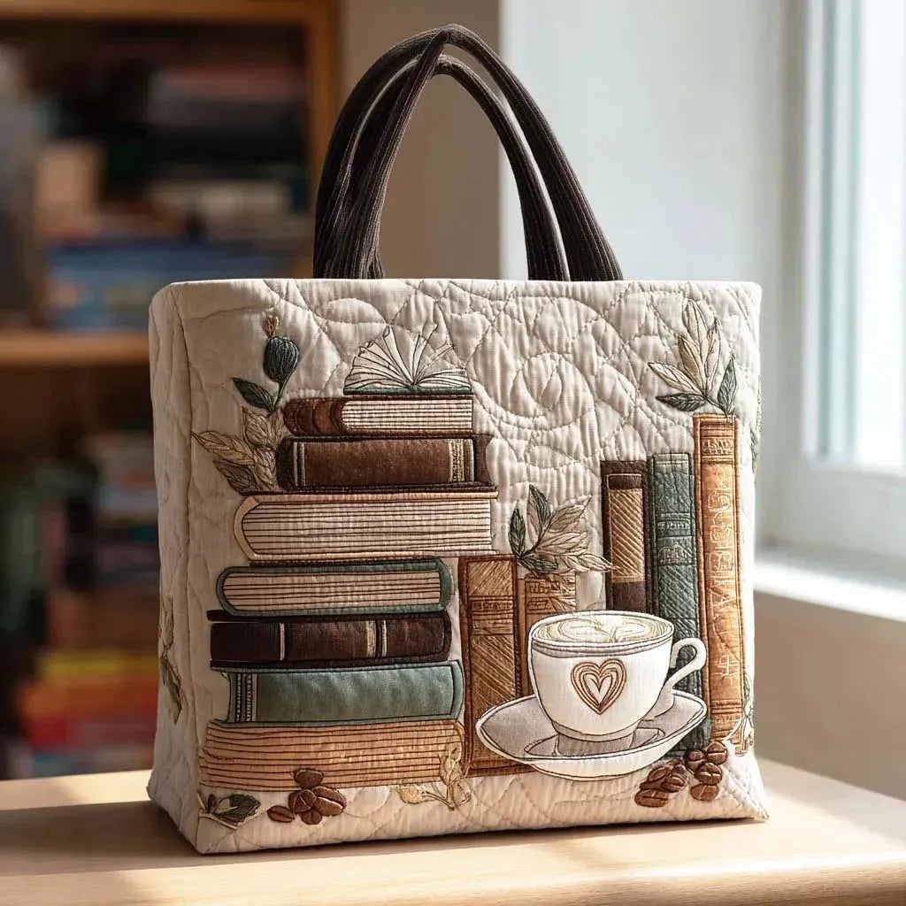 Quilted tote bag in warm tones with a coffee and books print on a wave-stitch body