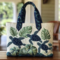 Quilted tote bag with a graceful sea turtle gliding through deep ocean blue on a structured padded body
