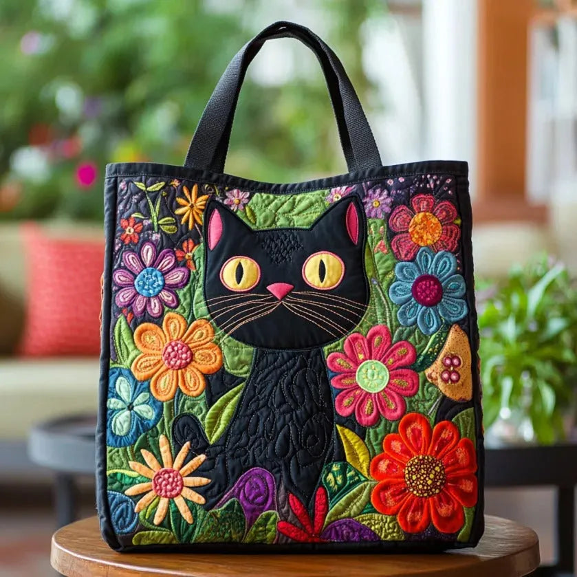 Quilted tote bag with a mysterious enchanted black cat motif on a structured padded body with wave-stitch detail