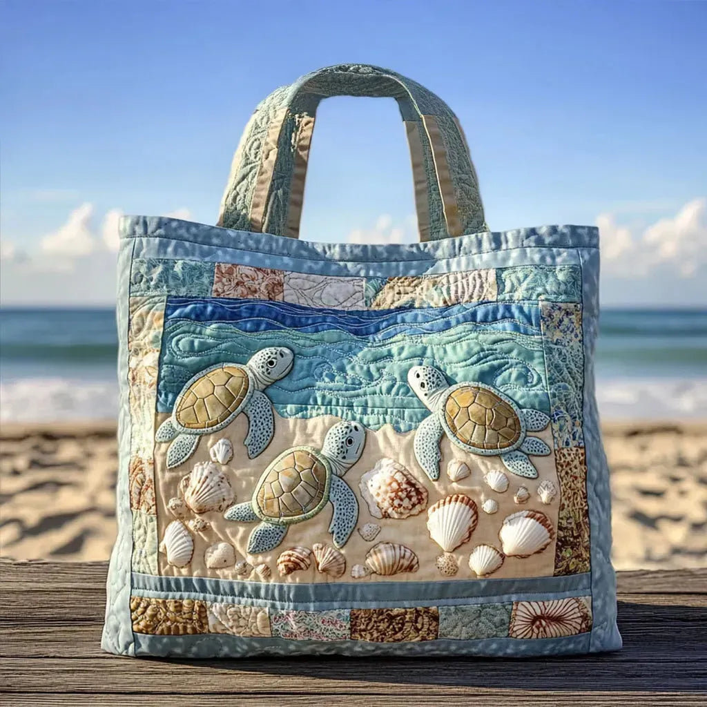 Quilted tote bag with sea turtles gliding through deep blue ocean water