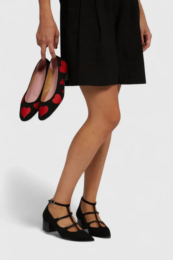 A woman walking through the city in leopard-print block heels, relaxed and confident.
