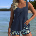 Navy and white striped tankini with matching shorts bottom, laid flat on a bright background