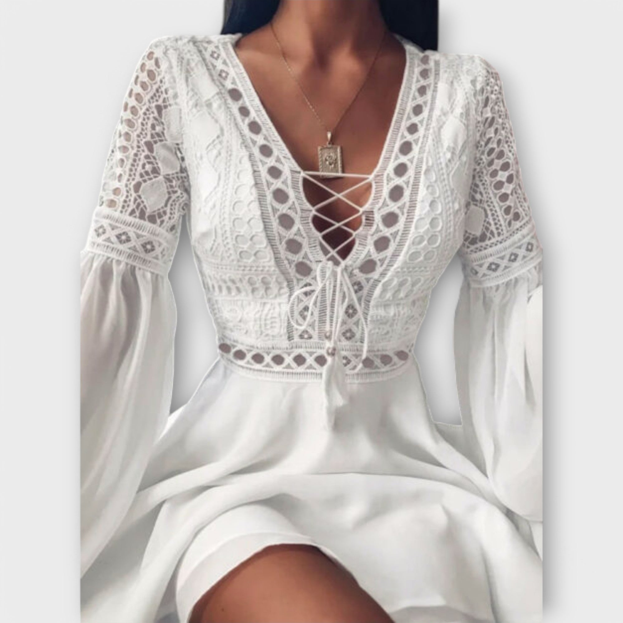 White short boho dress with delicate openwork trim, V-neckline tie and voluminous sleeves
