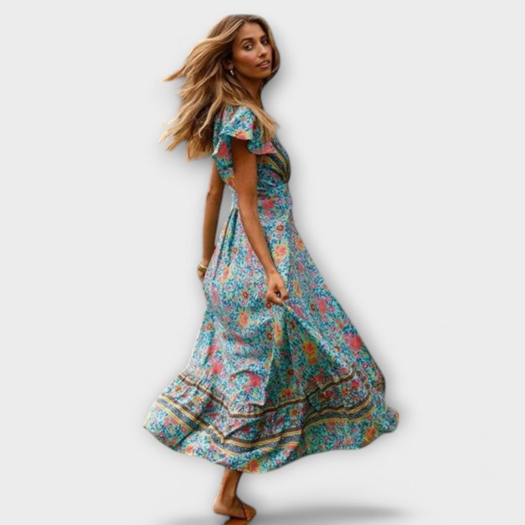 A flowing floral boho maxi dress in blue with a V-neckline, styled for a summer outing
