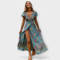 A flowing floral boho maxi dress in blue with a V-neckline, styled for a summer outing