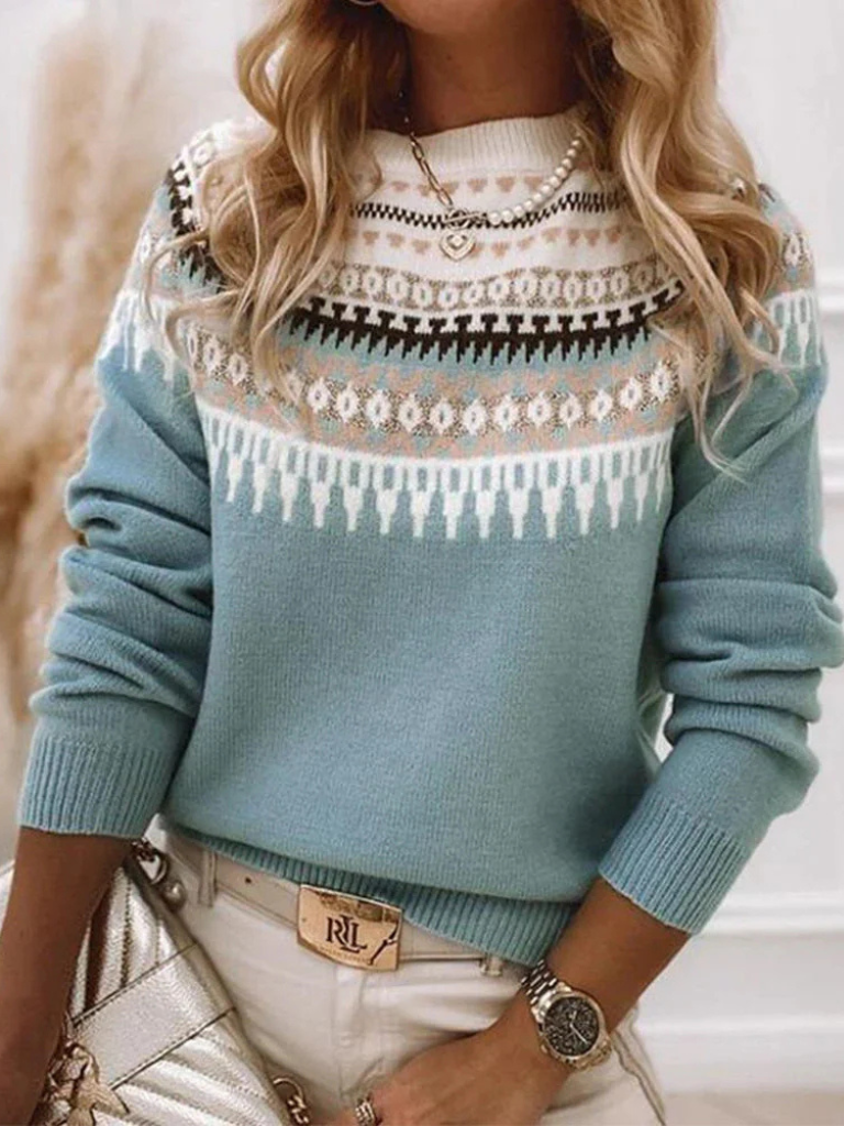 A woman wearing a soft jumper with a cream, black and beige Nordic pattern, warm and elegant.