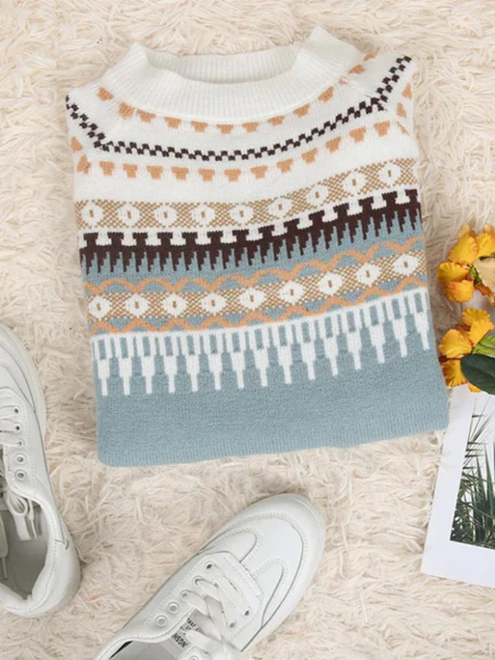 A woman wearing a soft jumper with a cream, black and beige Nordic pattern, warm and elegant.