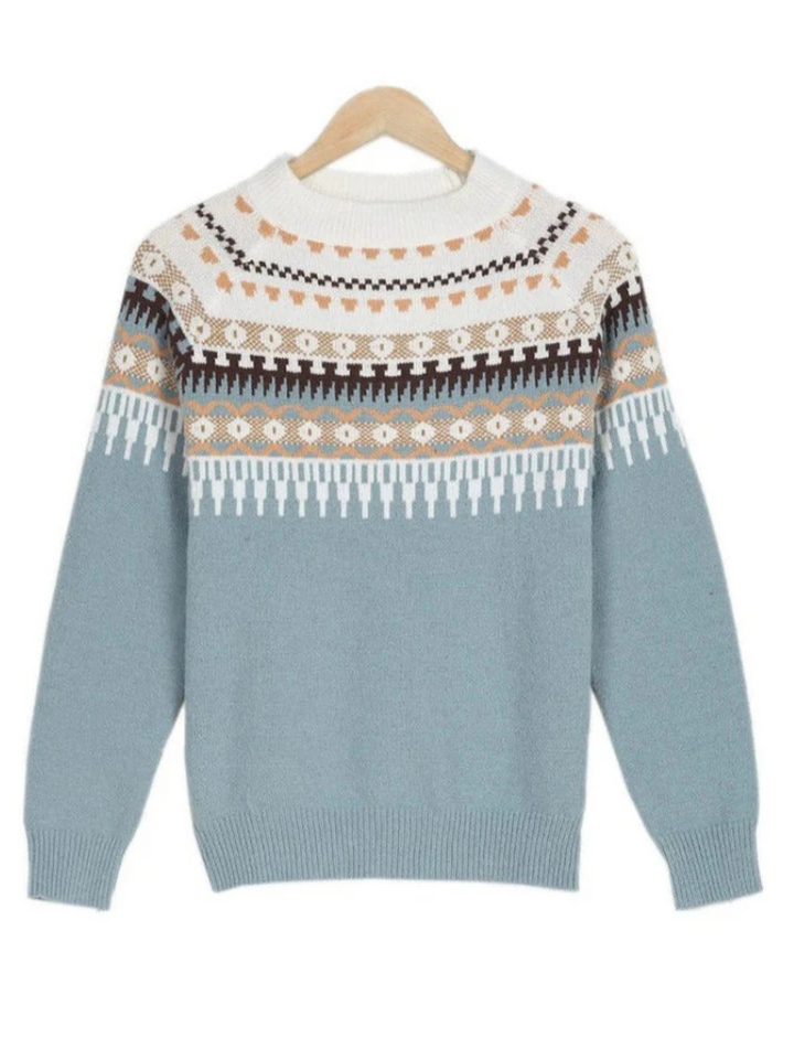 A woman wearing a soft jumper with a cream, black and beige Nordic pattern, warm and elegant.