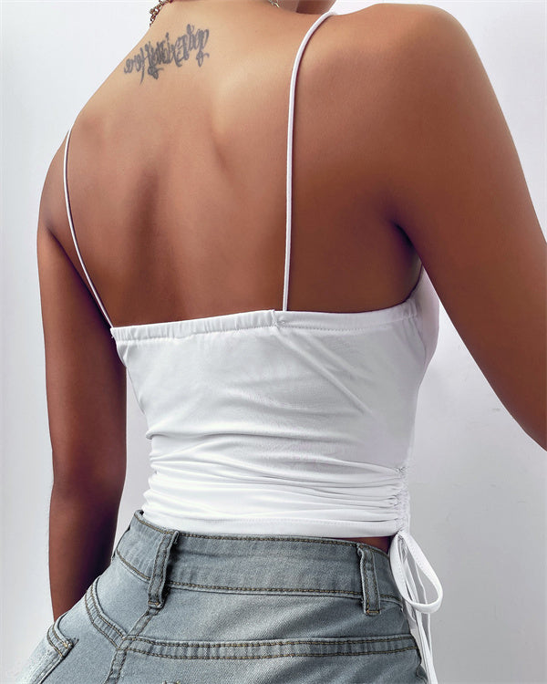 White sleeveless fitted top with adjustable side ties and a smooth, floaty drape